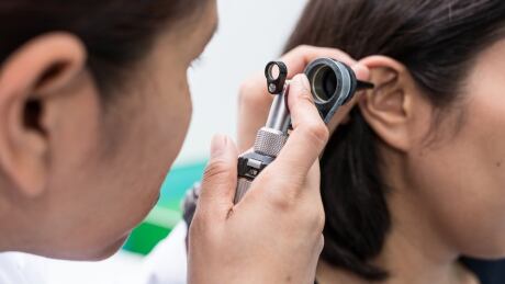 WorkSafeBC recommends people hired to work in noisy nightclubs, bars and restaurants have a baseline hearing test within the first six months of starting the job to be able to assess if their hearing declines during their employment. Doctor examining ear