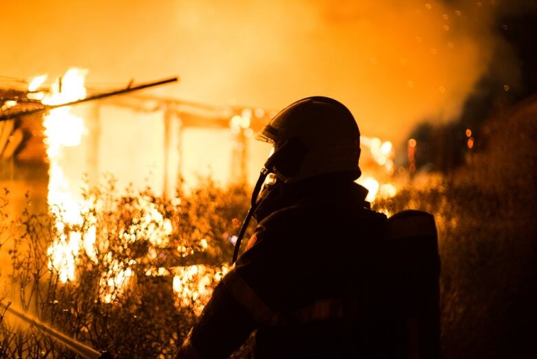 Firefighter Outside Burning Home