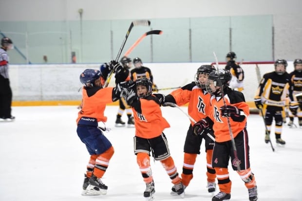 Team Revolution celebrates a goal on the ice (credit Team Revolution)