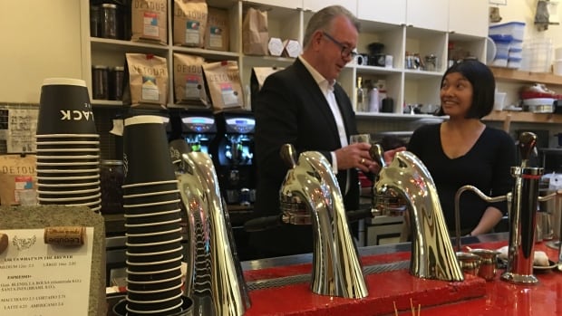 Ontario Labour Minister Kevin Flynn meets Nozomi Morimoto, a barista at HotBlack Coffee on Queen Street West in Toronto. She just received her first paycheque since the minimum wage went up. 