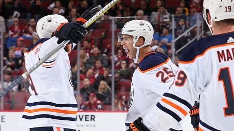 Darnell Nurse, left, of the Edmonton Oilers celebrates a goal with teammates Leon Draisaitl, centre, and Patrick Maroon during Edmonton's 4-2 win over the Arizona Coyotes on Friday. Oilers-Coyotes-12012018