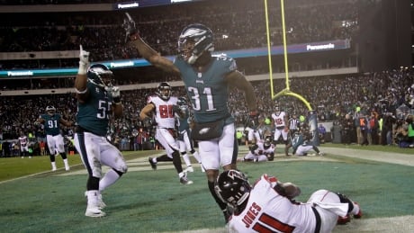 Jalen Mills (31) and Brandon Graham (55) of the Eagles celebrate after Julio Jones (11) fails to complete a fourth down pass to help Philadelphia defeat the Atlanta Falcons 15-10 on Saturday to advance to the NFC championship. Falcons-Eagles-13012018