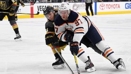 Connor McDavid skates with the puck against William Karlsson during the Edmonton Oilers' 3-2 win over the Vegas Golden Knights on Saturday. Connor McDavid