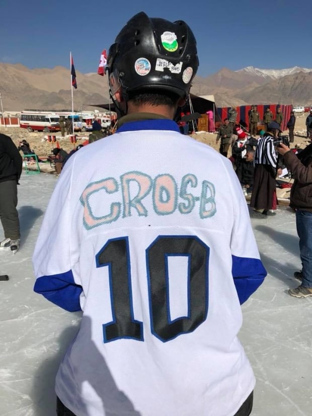 Hockey player in Leh, India poses with his jersey (Credit Wickenheiser Facebook)