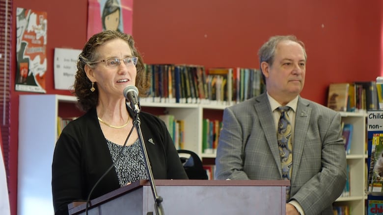A mayor speaks at a lectern during an announcement.