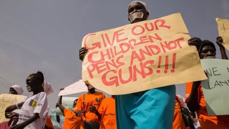 Women from more than forty South Sudanese women's organizations carry placards as march through the city on Dec. 9 to express the frustration and suffering that women and children face in Juba, South Sudan. AFP_V07SX