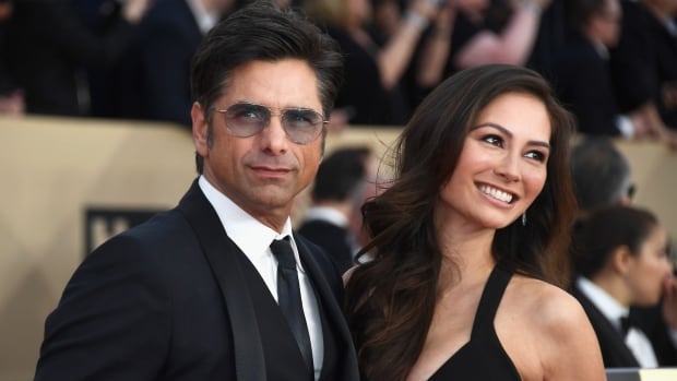 Caitlin McHugh seen with fiance John Stamos was robbed of thousands of dollars worth of jewelry from her hotel room Friday in Los Angeles Calif