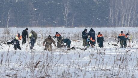 Russian Emergency Situations Ministry members work at the crash site of the short-haul AN-148 airplane operated by Saratov Airlines in Moscow Region, Russia February 12, 2018. REUTERS/Tatyana Makeyeva - UP1EE2C0SJF05 RUSSIA-AIRPLANE/CRASH