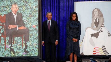 Former U.S. President Barack Obama and former first lady Michelle Obama stand with their portraits during the unveiling ceremony. USA-OBAMA/PORTRAIT Feb.12/18