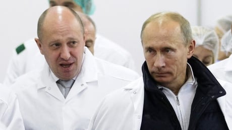 In this Monday, Sept. 20, 2010 file photo, businessman Yevgeny Prigozhin, left, shows Russian President Vladimir Putin, around his factory which produces school meals, outside St. Petersburg, Russia. Prigozhin was one of several Russians indicted on Friday.<br />
<br />
Trump Russia Probe