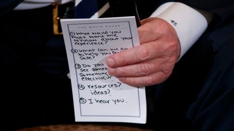 President Donald Trump holds notes during a listening session with high school students and teachers in the State Dining Room of the White House in Washington, Wednesday, Feb. 21, 2018. Trump heard the stories of students and parents affected by school shootings, following last week's deadly shooting in Florida. Trump Guns