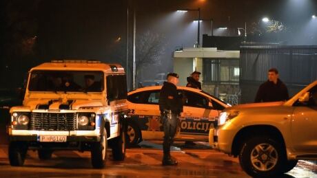 Police block off the area around the U.S. Embassy in Montenegro's capital Podgorica, early Thurday. The assailant hurled a hand grenade toward the embassy and then killed himself with another explosive device. Montenegro US Embassy