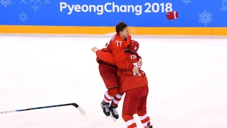 Kirill Kaprizov, left, leaps into the arms of Vyacheslav Voinov, right, after scoring the overtime winner to secure gold for OAR in men's hockey in Pyeongchang on Sunday. kaprizov-kirill-022518