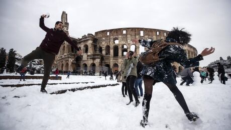 epa06566429 People take part in a snowball fight in front of the Colosseum covered by snow during a snowfall in Rome, Italy, 26 February 2018. Media reports on 26 February state that extreme cold weather is forecast to hit many parts of Europe with temperatures plummeting to a possible ten year low. EPA-EFE/ANGELO CARCONI ITALY COLD WEATHER