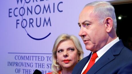 Israel's Prime Minister Benjamin Netanyahu talks to the media next to his wife Sara during the World Economic Forum in Davos, Switzerland on Jan. 25, 2018. DAVOS-MEETING/NETANYAHUS