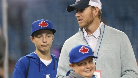 The late Roy Halladay is seen with his sons Braden and Ryan before a Toronto Blue Jays game against the New York Yankees on April 4, 2014 at Rogers Centre in Toronto. Roy Halladay