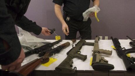 OPP officers prepare to bag a firearm after Ontario Provincial Police host a news conference in Vaughan, Ont., on Thursday, February 23, 2017. The Liberals are planning to introduce legislation in coming weeks to fulfil platform promises on firearms, including a requirement for "enhanced background checks" for anyone seeking to buy a handgun or other restricted gun. Guns and Gangs 20180307
