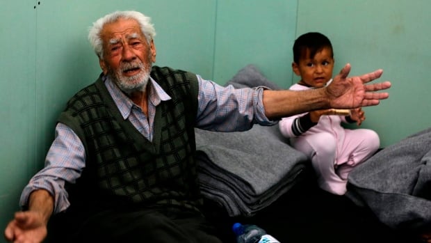 Displaced Syrian civilians gather Monday at a government-run shelter on the outskirts of Damascus after they were evacuated by the army from areas in the eastern Ghouta region recently recaptured from rebels by government forces
