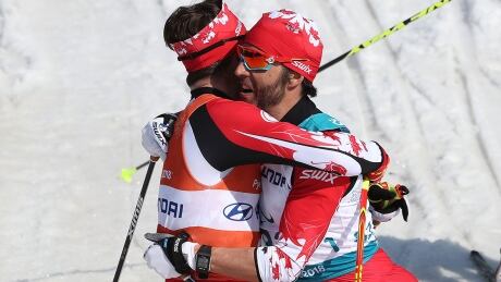 Brian McKeever, right, embraces guide Russell Kennedy after winning gold in the men's 1.5-kilometre cross-country sprint. Brian McKeever Russell Kennedy