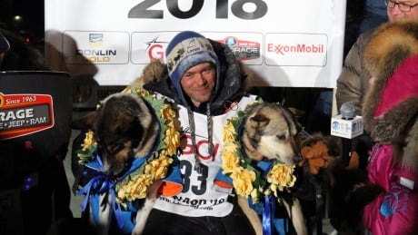 Joar Ulsom of Norway poses with his dogs after winning the Iditarod sled dog race in Nome, Alaska, Wednesday, March 14, 2018. Joar Ulsom