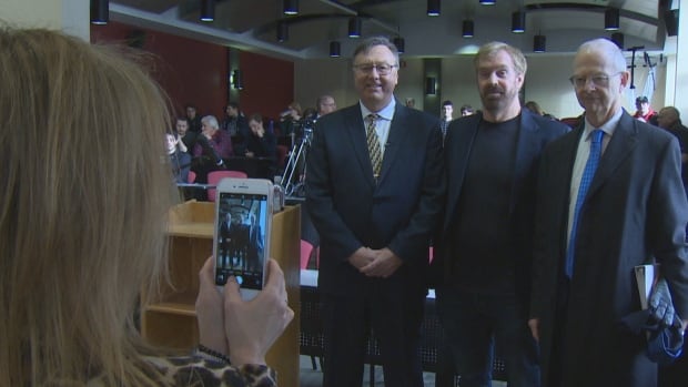 Leadership candidates Tony Wakeham, right, and Ches Crosbie, left, pose with moderator Stephen Tomblin before a debate at Memorial University Thursday.