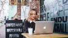 Kailea Switzer on laptop at coffee shop 