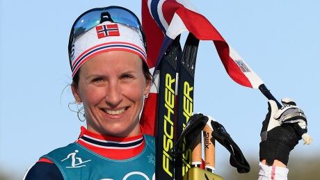 Norway's Marit Bjoergen, pictured here celebrating her Olympic victory in the ladies' 30-kilometre mass start classic in February, is retiring from cross-country skiing at age 38. She has won 15 Olympic medals, including eight gold, and 114 individual World Cup races. bjoergen-marit-180225-1180