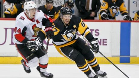 Sidney Crosby, right, picked up a goal and an assist as the Pittsburgh Penguins shut out the Ottawa Senators 4-0 on Friday. sidney-crosby