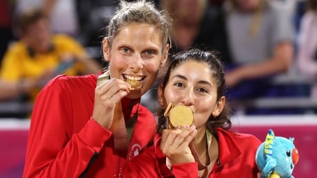 Canada's Sarah Pavan, left, and Melissa Humana-Paredes celebrate after winning the gold medal in women's beach volleyball at Coolangatta during the 2018 Commonwealth Games on the Gold Coast, Australia, Thursday, April 12. Canada won gold, Australia silver and Vanuatu won bronze. Australia Commonwealth Games Beach Volleyball