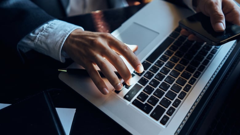 an AI image of a man typing on a computer