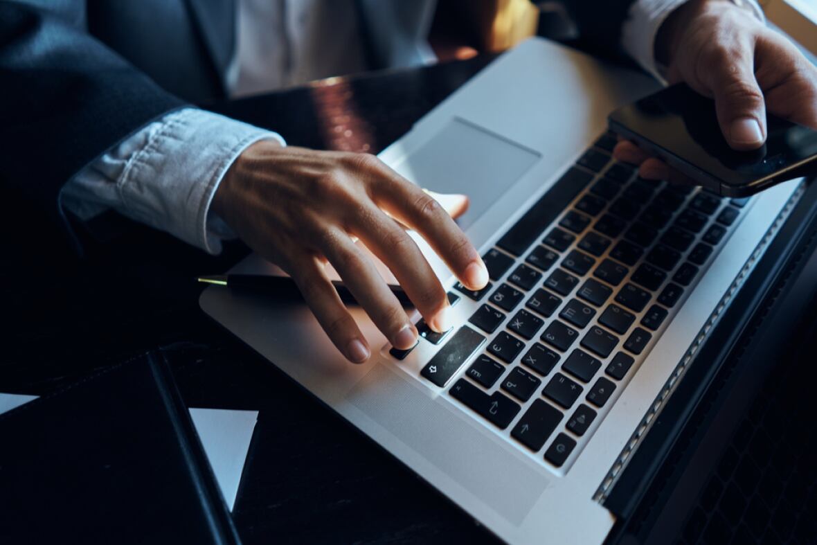 an AI image of a man typing on a computer