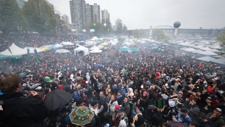 Smoke fills the air above the thousands of people gathered around the stage shortly after the clock struck 4:20 p.m. in Vancouver on Friday. Vancouver 4/20