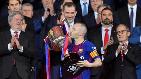 Barcelona captain Andres Iniesta kisses the Copa del Rey as Spain's king Felipe VI, above with stripped tie, looks on. The Catalan club defeated Sevilla 5-1 on Saturday to claim its fourth straight King's Cup trophy.
Iniesta-Andres-21042018