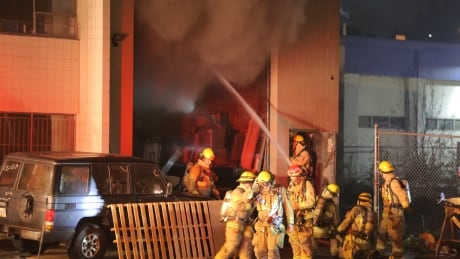 Thick smoke billows out of the shop, after crews broke through the front gate. BURNABY WAREHOUSE FIRE APRIL 22 2018