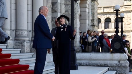 Premier John Horgan greets Lieutenant-Governor Judith Guichon after her inspection of the honour guard in farewell ceremony at B.C.'s legislature on Apr. 23, 2018. Guichon Horgan