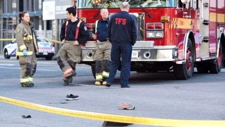 Shoes lay in the street as first responders secure the area in Toronto after a van mounted a sidewalk crashing into a number of pedestrians on Monday, April 23, 2018. Pedestrians Struck 20180423