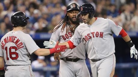 J.D. Martinez, right, of the Red Sox is congratulated by teammates Andrew Benintendi and Hanley Ramirez after hitting a three-run home run to help Boston seal a 5-4 win over the Toronto Blue Jays on Thursday.
Jays-RedSox-26042018