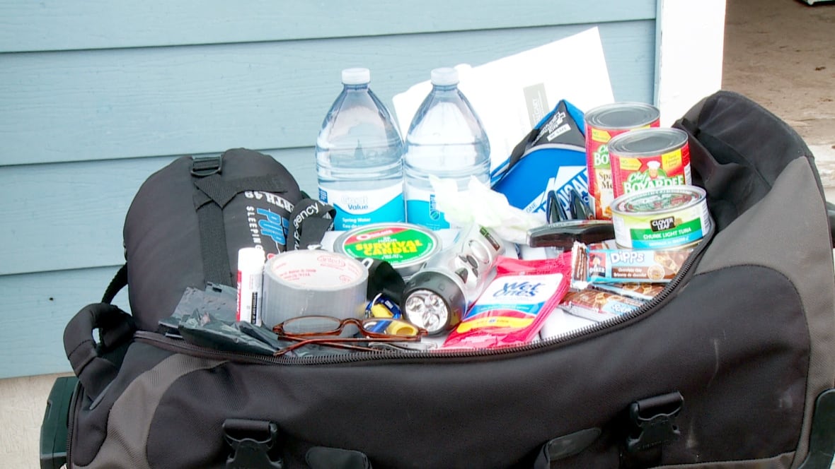 Duffle bag containing canned food, clothing, and bottled water