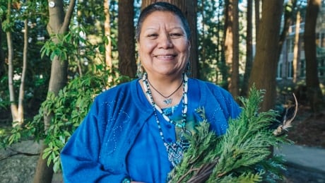Elder Roberta Price holds cedar and an eagle feather she brings to ceremonies and healing work. Roberta Price
