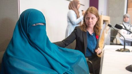 Marie-Michelle Lacoste, who now goes by Warda Naili after converting to Islam, left, and her lawyer Catherine McKenzie take their seats at a news conference Tuesday, November 7, 2017 in Montreal. The National Council of Canadian Muslims and the Canadian Civil Liberties Association announced the launch of their constitutional lawsuit filed in Quebec Superior Court against Bill 62,THE CANADIAN PRESS/Ryan Remiorz QUE Muslim Lawsuit20171107