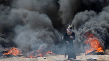 A female Palestinian demonstrator gestures during a protest against U.S. embassy move to Jerusalem and ahead of the 70th anniversary of Nakba, at the Israel-Gaza border on Monday. ISRAEL-USA/PROTESTS-PALESTINIANS