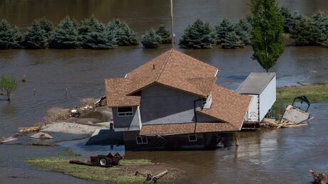 A home damaged by floodwaters is seen in an aerial view, near the Kettle River in Grand Forks, B.C. BC Flooding 20180512