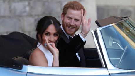 The newly married Duke and Duchess of Sussex, Meghan Markle and Prince Harry, leave Windsor Castle in a convertible car after their wedding in Windsor, England, to attend an evening reception at Frogmore House, hosted by the Prince of Wales, Saturday, May 19, 2018. Britain Royal Wedding