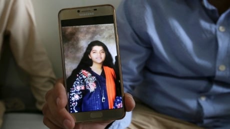 Abdul Aziz Sheikh shows a picture of his daughter Sabika in Karachi, Pakistan, on Saturday, May 19, 2018. The Pakistani foreign exchange student was among those killed in a shooting at a Texas high school on Friday. Pakistan US School Shooting Texas Victims
