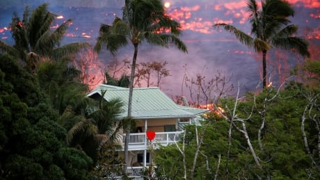 Lava flows near a house on the outskirts of Pahoa during ongoing eruptions of the Kilauea Volcano. HAWAII-VOLCANO/