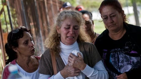 Grieving relatives of passengers who perished in Cuba's worst aviation disaster leave the morgue, in Havana, Cuba, Saturday, May 19, 2018. Investigators are trying to determine why an aging Boeing 737 carrying more than 100 people went down and erupted in flames shortly after takeoff in Havana. (AP Photo/Ramon Espinosa) APTOPIX Cuba Plane Crash
