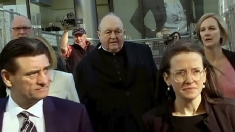 In this image made from video, Archbishop Philip Wilson, center, heads to Newcastle Local Court, north of Sydney, Australia Tuesday, May 22, 2018. The Australian archbishop who was the most senior Roman Catholic cleric in the world charged with covering up child sex abuse was convicted Tuesday. (Australian Broadcasting Corporation via AP) Australia Church Abuse