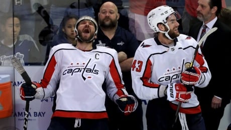 Washington's Alex Ovechkin and Tom Wilson celebrate on the bench after defeating the Tampa Bay Lightning in Game 7. ovechkin-alex
