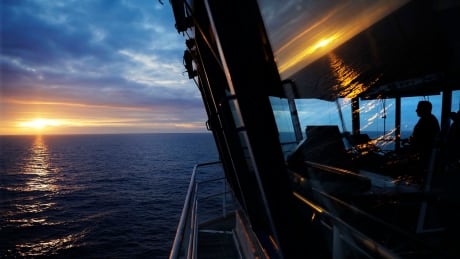 File - In this July 7, 2018 file photo, First officer Jukka Vuosalmi sits at the controls of the Finnish icebreaker MSV Nordica as it sets sail in the North Pacific Ocean toward the Bering Strait. The International Maritime Organization has approved two-way shipping routes into the Arctic Ocean through the Bering Strait. The IMO accepted routes proposed by the United States and Russia for safe navigation between Alaska and Russia's Chukotskiy Peninsula. The routes create lanes for northbound and southbound traffic and take effect Dec. 1, 2018. (AP Photo/David Goldman, File) Arctic Shipping Lanes