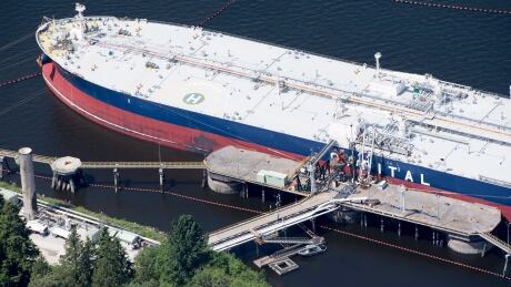A aerial view of Kinder Morgan's Trans Mountain marine terminal filling a oil tanker in Burnaby, B.C., is shown on Tuesday, May 29, 2018. Kinder Morgan Canada is paying $1.5-million bonuses to two senior executives to ensure they stay with the company as its Trans Mountain pipeline system is sold to the federal government under a $4.5-billion sales agreement. THE CANADIAN PRESS Jonathan Hayward Trans Mountain 20180529